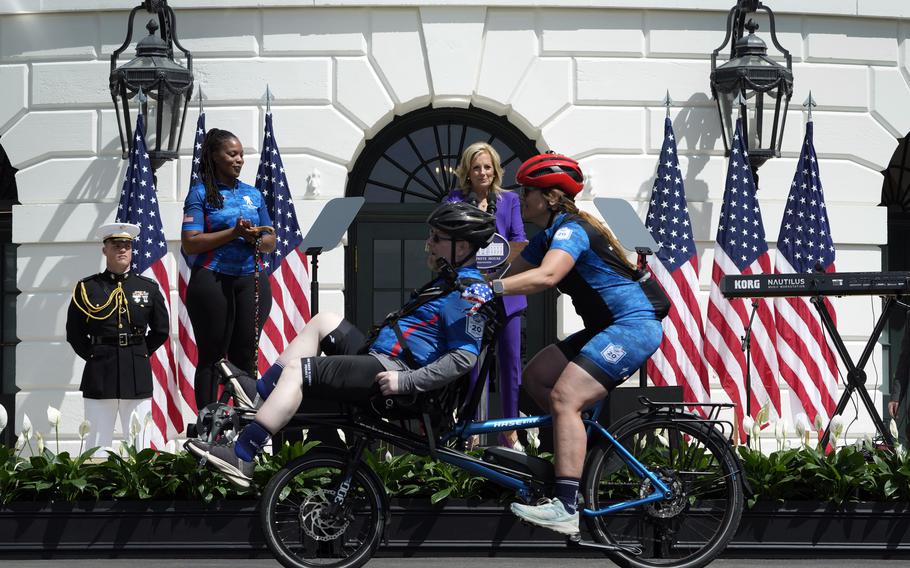 First lady Jill Biden, in purple, and Sharona Young, retired naval chief petty officer, second from left, watch as riders begin the Wounded Warrior Project’s Soldier Ride on the South Lawn of the White House in Washington on Wednesday, April 24, 2024. 