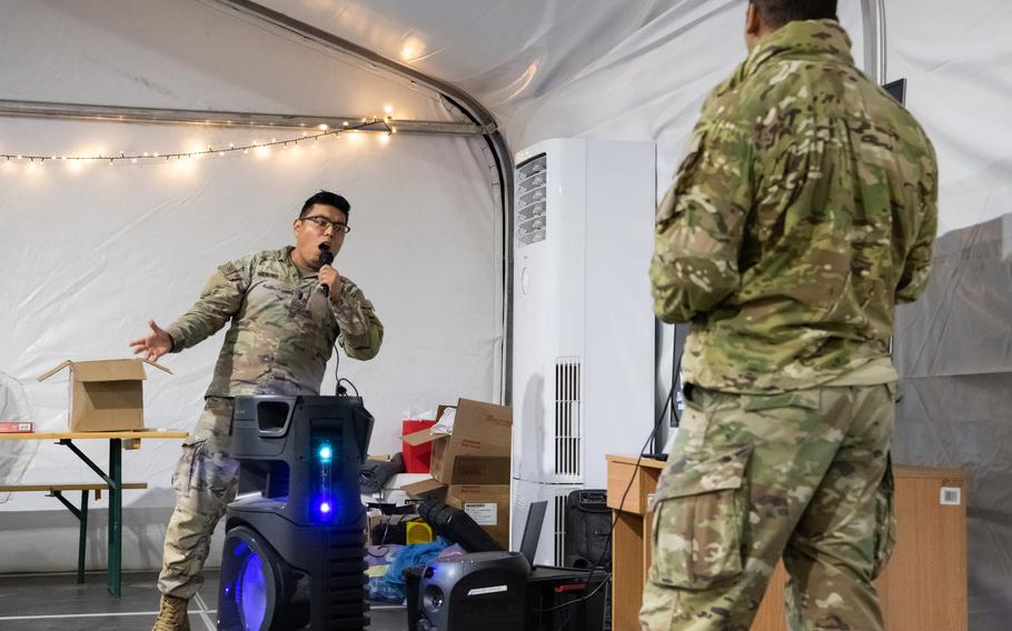 Army Lt. Aldhair Merino, of the 1st Infantry Division, sings Frank Sinatra’s “My Way” during a karaoke performance in Boleslawiec, Poland, on Dec. 14, 2022.
