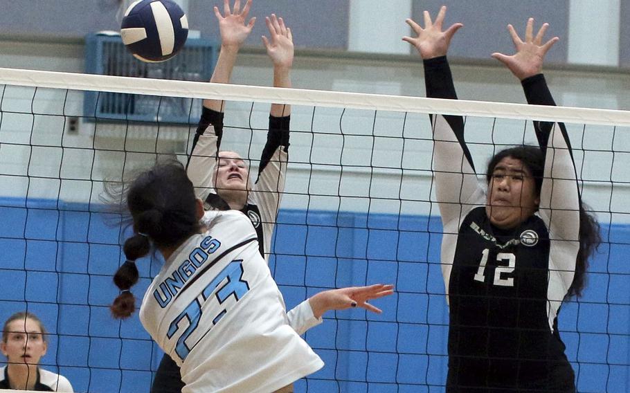 Osan's Shaylee Ungos spikes against Humphreys' Elizabeth Troxel and Bella Pula during Saturday's DODEA-Korea girls volleyball district finals. The Blackhawks won the championship match in four sets.