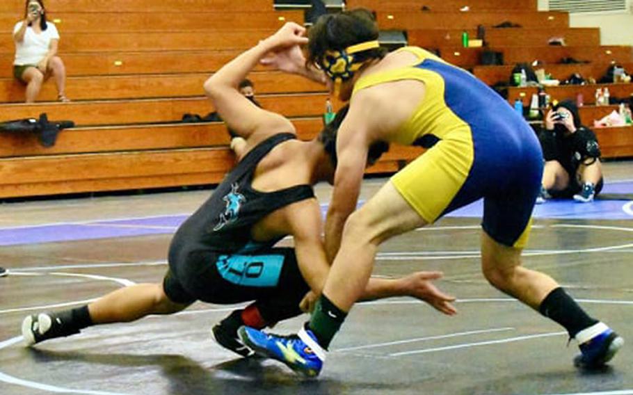 Guam High's Victor Babauta tries to stop a shot by Southern's Ely Pocaigue during Saturday's Guam wrestling dual meet. Pocaigue pinned Babauta in 4 minutes, 37 seconds, and the Dolphins won the meet 39-27.