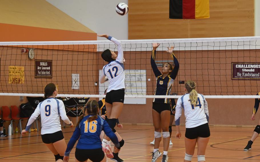 Wiesbaden’s Nicole Suh goes up for the contested spike against Ansbach’s Laila McIntyre during their scrimmage at the Vilseck High School gym on Sept. 2, 2023.