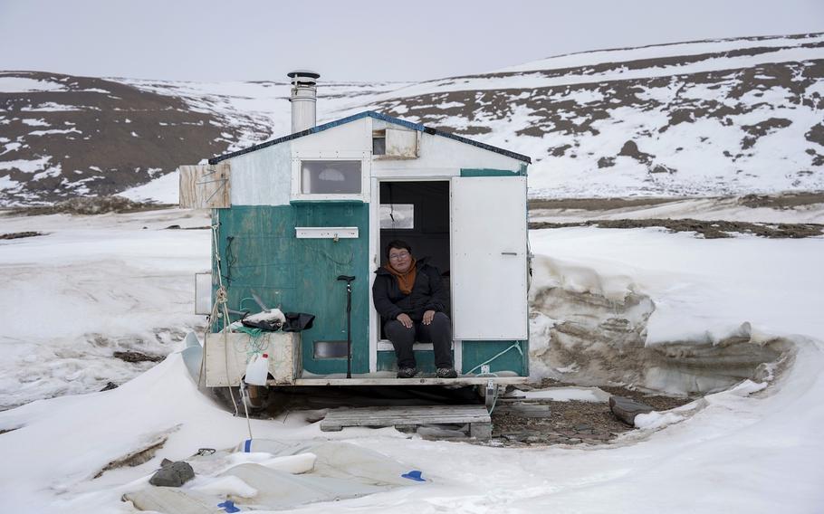 Toku Oshima a hunter worried about climate change, is seen at her fishing camp. She hopes to get her community to shift to greener sources of energy. 
