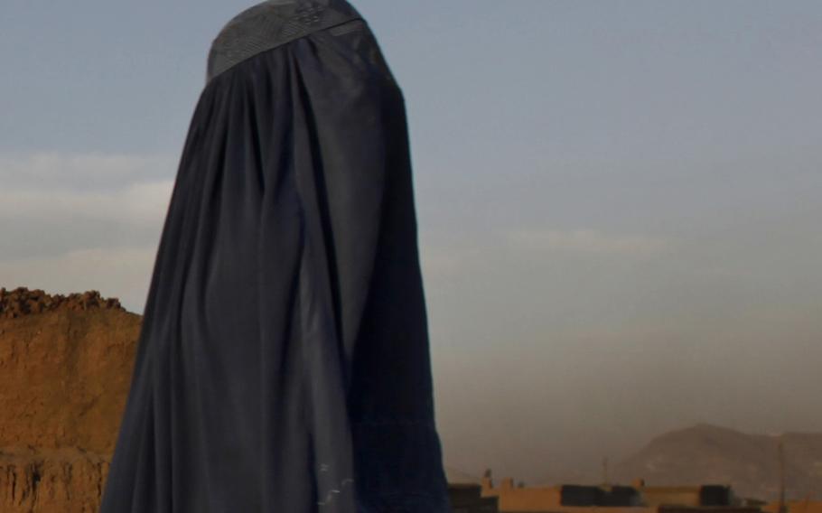 An Afghan woman in a burka walks through a suburb of Kabul, Afghanistan, on Sept. 25, 2010.  On Saturday, Sept. 11, 2021, women in full face veils rallied in support of the Taliban and its policies of gender segregation, a demonstration that was flanked by Taliban fighters carrying machine guns and rifles.