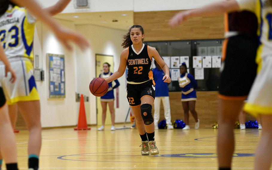 Spangdahlem freshman Jayda Lewis surveys the floor against Sigonella during pool-play action on Feb. 15, 2024, at Wiesbaden Middle School in Wiesbaden, Germany.