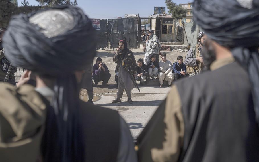 Taliban fighters secure the area after a roadside bomb went off in Kabul Afghanistan, Monday Nov. 15, 2021. 