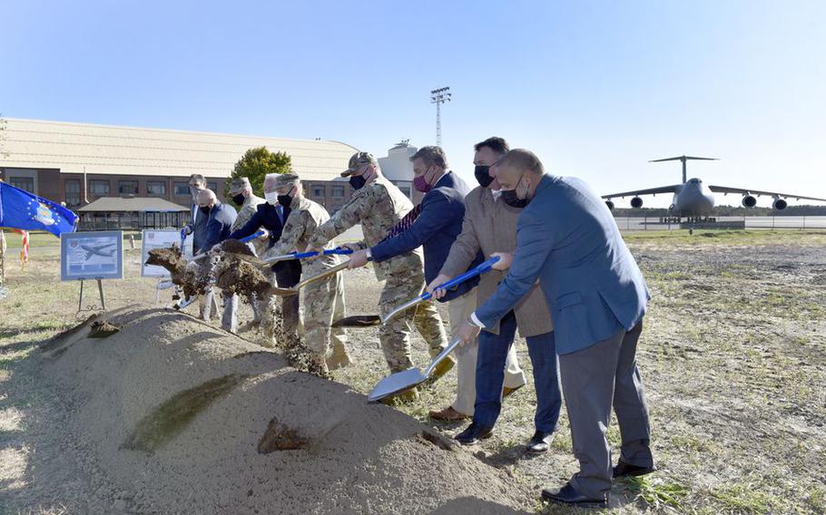 Officials shovel some dirt at Westover Air Reserve Base during a groundbreaking ceremony for a new Regional ISO Maintenance Hangar on the base.