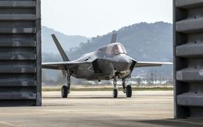 A view of a Marine Corps F-35B Lighting II through hangar doors.