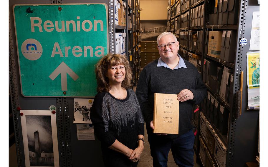 City Archivist John Slate, holding Volume No. 1 of the Dallas City Council's minutes from 1874-75, and Assistant City Archivist Kristi Nedderman inside the Dallas Municipal Archives vault in late December. 