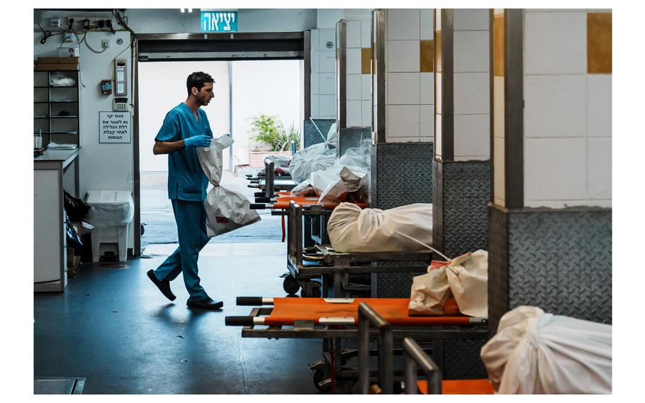 Nir Blatman organizes incoming shipment of human remains recovered from the communities near the Gaza border where Hamas focused their unprecedented assault for further examination at the Institute of Forensic Medicine in Tel Aviv, Israel, on Nov. 7, 2023. 