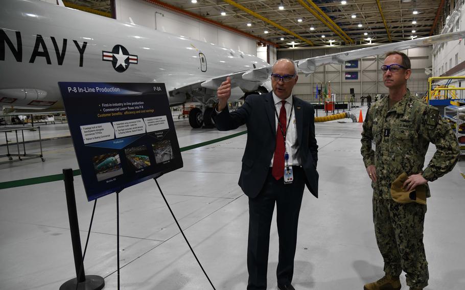 Vice Adm. John B. Mustin receives a tour from Perry Yaw, business development lead for the Boeing P8 Program, before taking delivery of the first new P-8A Poseidon for the Naval Air Force Reserve during a ceremony in Tukwila, Washington, March 6, 2024.