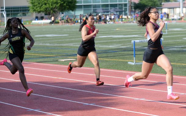 Zama's Paula Adams leads the field home as she captures first place in the 200-meter Far East track and field meet prelimiaries.
