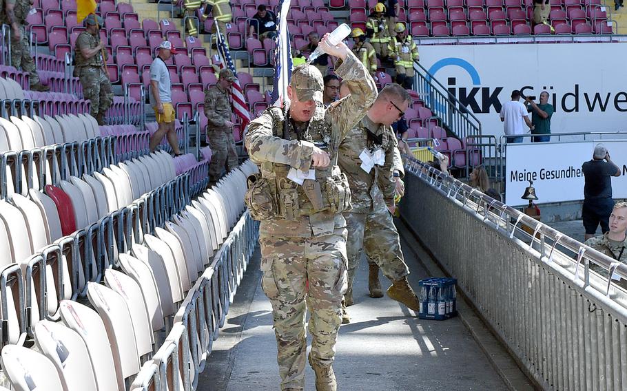 Senior Master Sgt. Trevor Derr, of the 721st Aircraft Maintenance Squadron, douses himself with water during the 9/11 Stair Climb event on Sept. 11, 2023, at Fritz Walter Stadium in Kaiserslautern, Germany. The event honored the New York City firefighters who died during the Sept. 11, 2001, terrorist attacks.