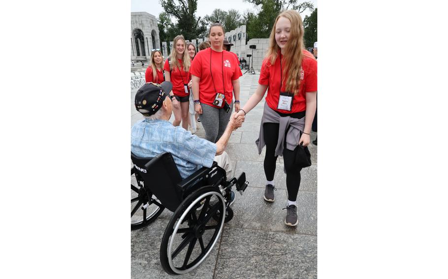 World War II veteran Les Jones greets students from Kenosha, Wis., at the World War II Memorial on the National Mall in Washington, D.C., on Memorial Day, May 29, 2023.