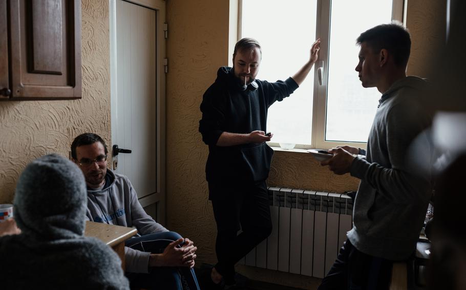 Residents of a shelter provided by Kovcheg, a Russian immigrant support group, gather in the kitchen on Feb. 1 in Yerevan, Armenia.