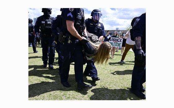 Police take a pro-Palestine protester to a Denver sheriff's bus to be processed as law enforcement officers cleared a protest encampment on the Auraria Campus on Friday, April 26, 2024, in Denver. (Andy Cross/The Denver Post/TNS)