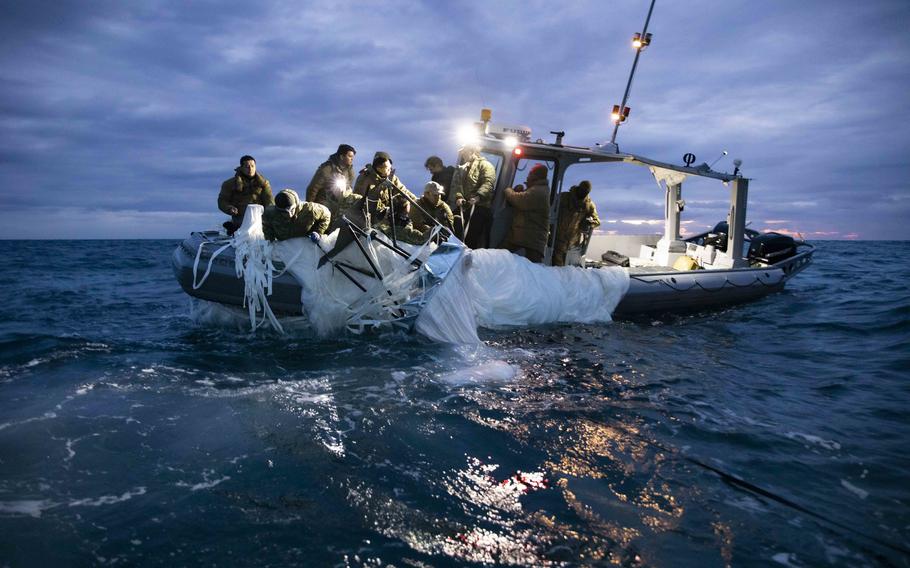 Sailors assigned to Explosive Ordnance Disposal Group 2 recover a high-altitude surveillance balloon off the coast of Myrtle Beach, South Carolina, Feb. 5, 2023.