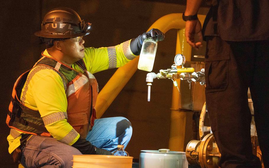 A worker supporting Joint Task Force-Red Hill inspects fuel from the Red Hill Bulk Fuel Storage Facility at Joint Base Pearl Harbor-Hickam, Hawaii, Nov. 7, 2023.  