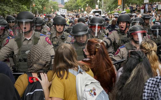 Texas state troopers in riot gear try to beak up a pro-Palestinian protest at the University of Texas in Austin on April 24, 2024.
