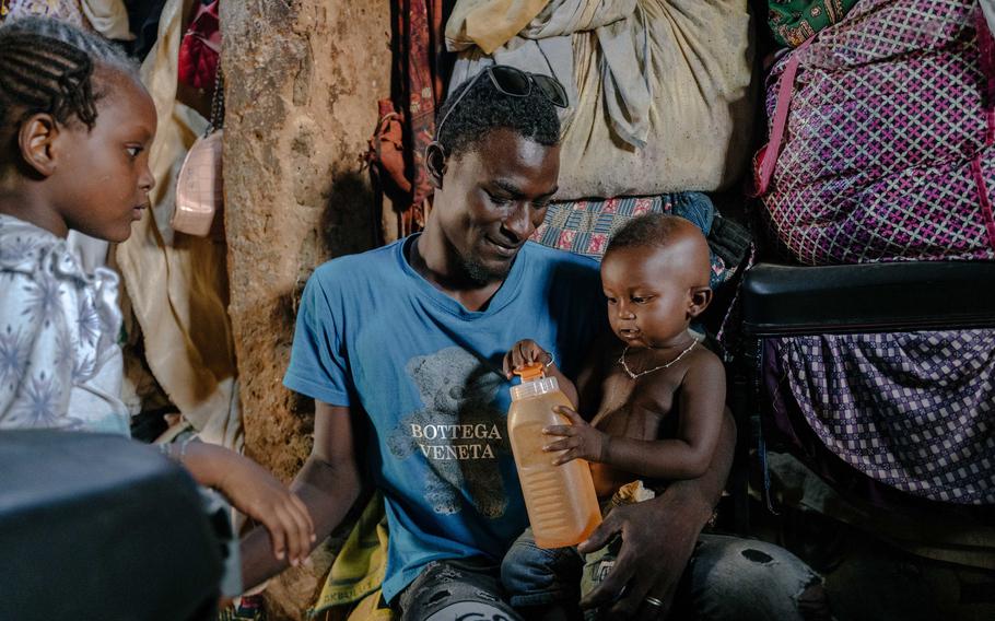 Abdoul Wahab, center, holds his 15-month-old nephew Issa Abdoulaye in the family’s house in Niamey. Wahab’s brother was killed during an attack by Islamist extremists on soldiers in Tillabéri in September.