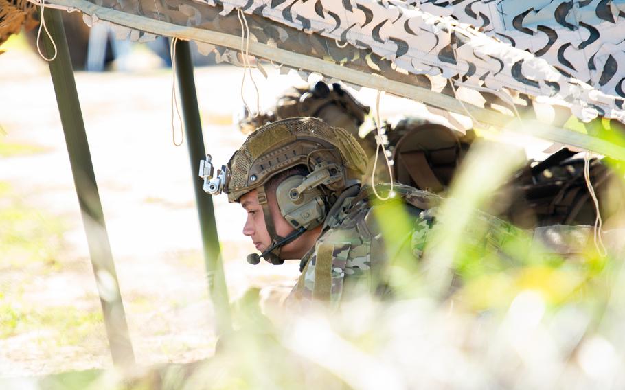 Army Rangers from the 2nd Ranger Battalion, 75th Ranger Regiment take cover while controlling a drone swarm during a demonstration March 5, 2024, during Project Convergence at Camp Pendleton, Calif. The Army-led Project Convergence is an experiment to bring all the military services together to link their intelligence-gathering sensors to all their offensive and defensive fires capabilities and test new age technology that the Defense Department hopes to field to the force. 