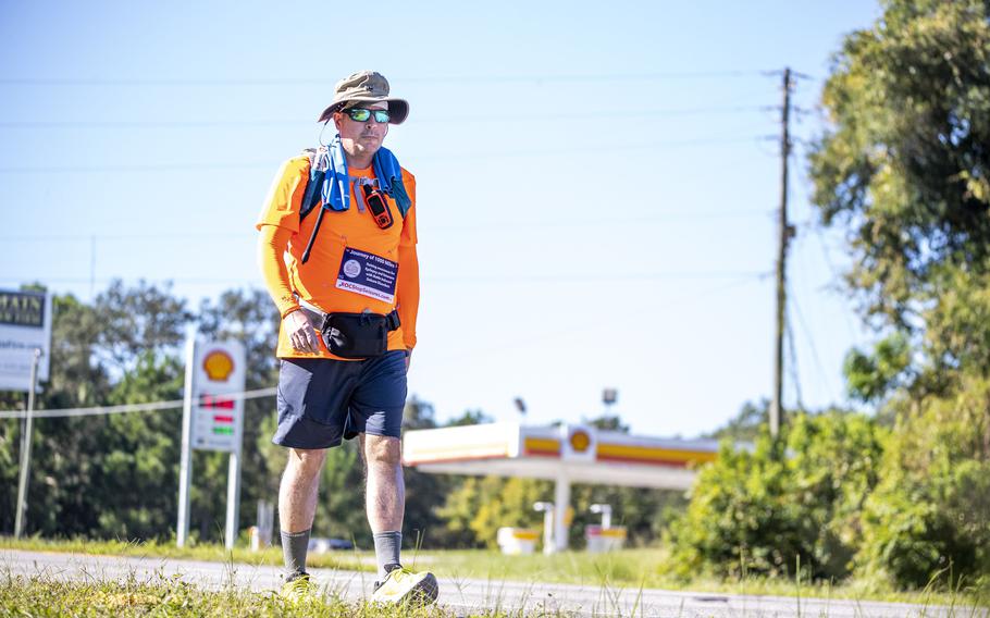 Ryan “ROC” O’Connor sets off for Day 2 of his Journey of 1,000 Miles, walking along U.S. Highway 441 in Mount Dora, Fla., on Sunday, Oct. 2, 2022.