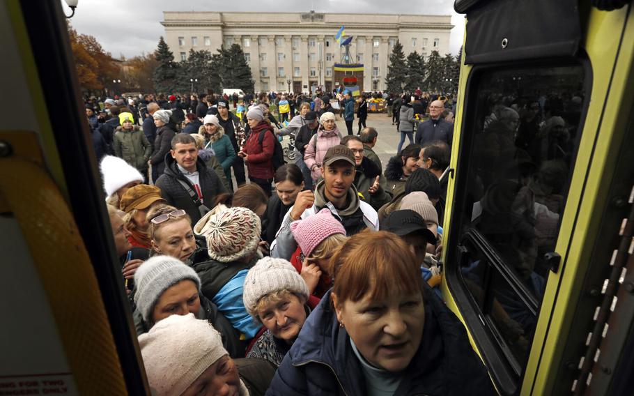 People line up in the main square in Kherson, Ukraine, on Nov. 16, 2022, to get medicine. As the people of Kherson emerge from months of Russian occupation, there is no running water and electricity and food is in short supply on Nov. 16, 2022. 