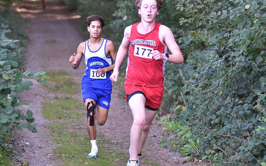 Kaiserslautern junior Jacob Porter pulls away from Royal Frank Lozano in the woods during a Sept. 30, 2023, meet at Ramstein High School on Ramstein Air Base, Germany. Porter set a new personal record with a winning run of 16:41. Lozano took second place in a time of 17:17.