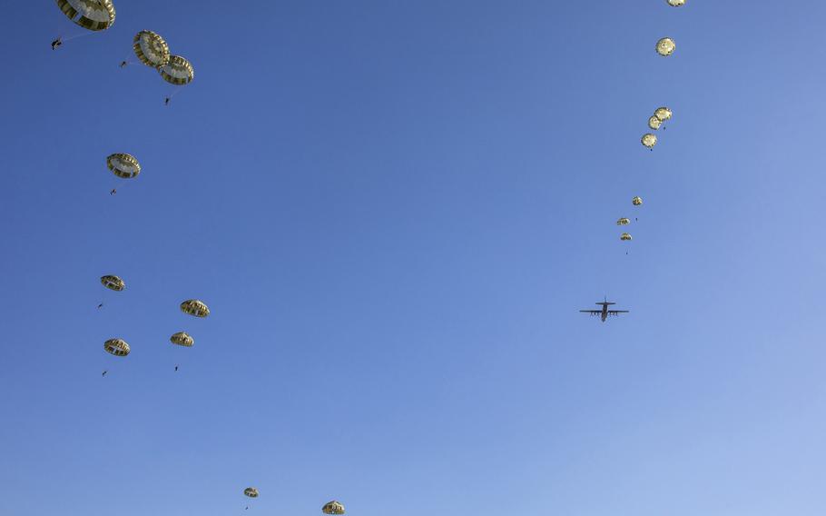 Japanese troops jump from an Air Force C-130J Super Hercules above Camp Narashino, Japan, Thursday, Jan. 13, 2022. 