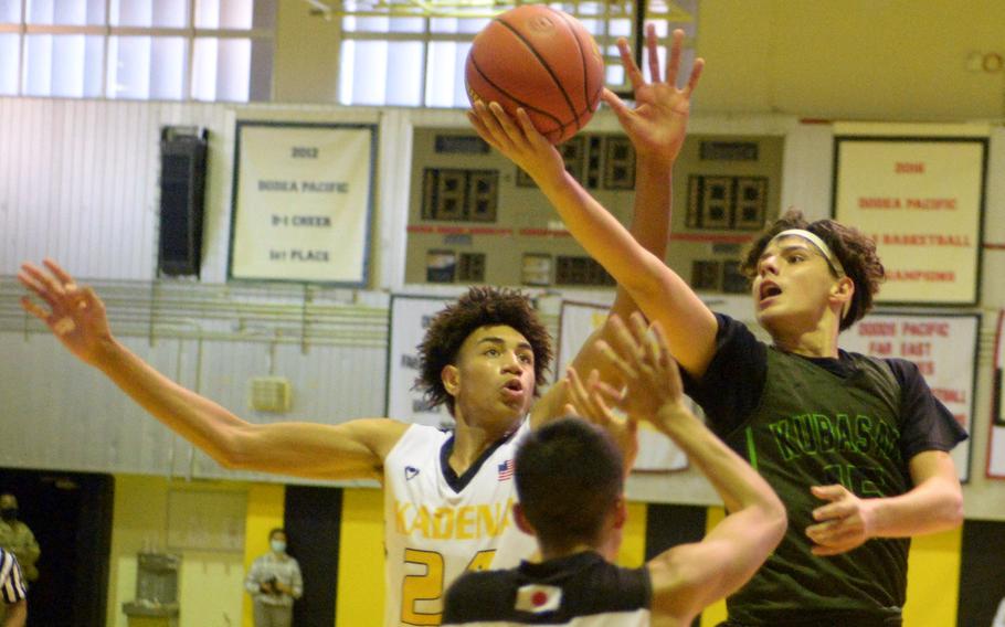 Kubasaki's Niko Arroyo shoots against Kadena's Jeremiah Lewis during Thursday's Okinawa basketball game. The Panthers rallied from an 11-point deficit to win 39-34.