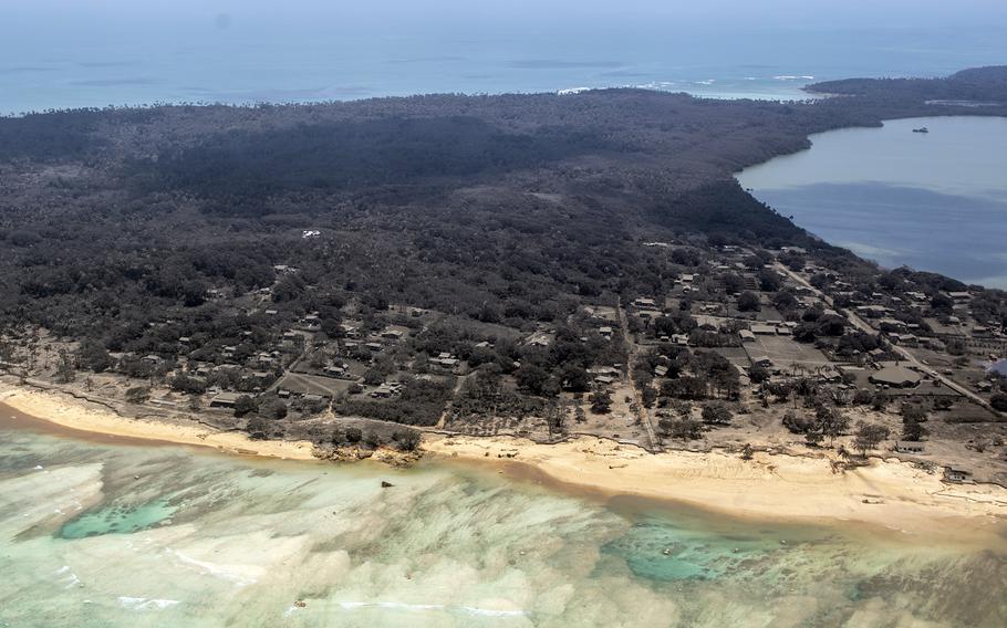 Volcanic ash covers a Tongan village in this photograph taken from a Royal New Zealand Air Force P-3K2 Orion aircraft, Monday, Jan. 17, 2022. 