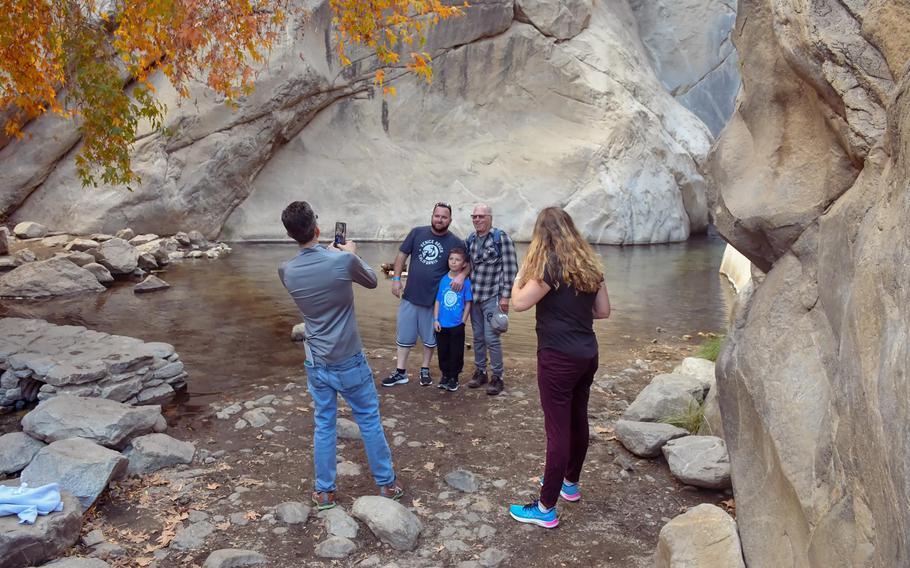 Geyorg Baker, 9, is flanked by his father, Brenden Baker, 45, and grandfather John Hermansen, 78, on a hike in Tahquitz Canyon, Palm Springs. 