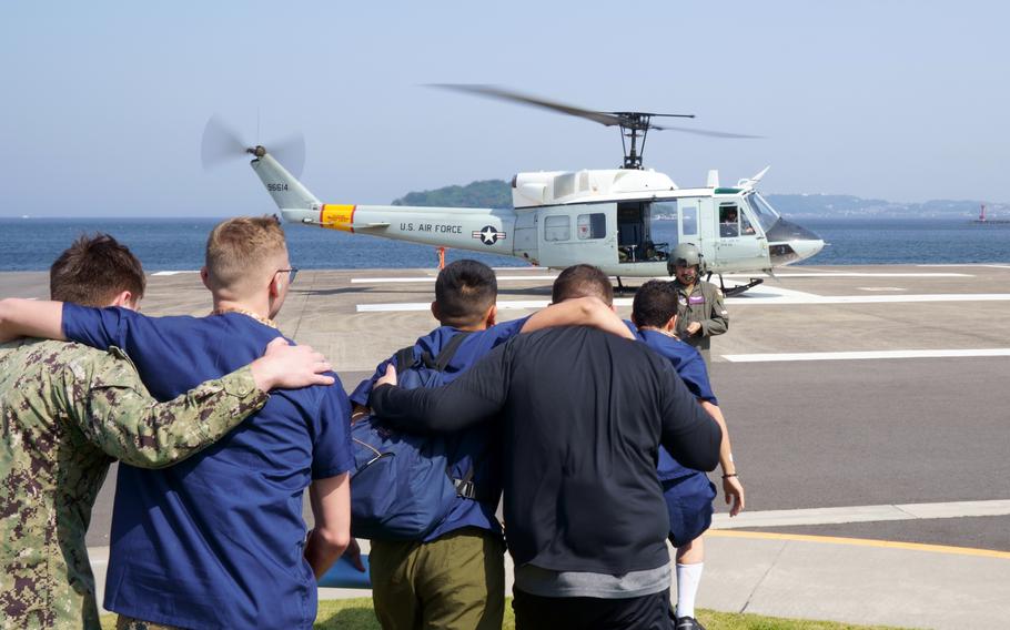 Actors taking part in an earthquake-response drill are evacuated by helicopter at Yokosuka Naval Base, Japan, Thursday, May 18, 2023.