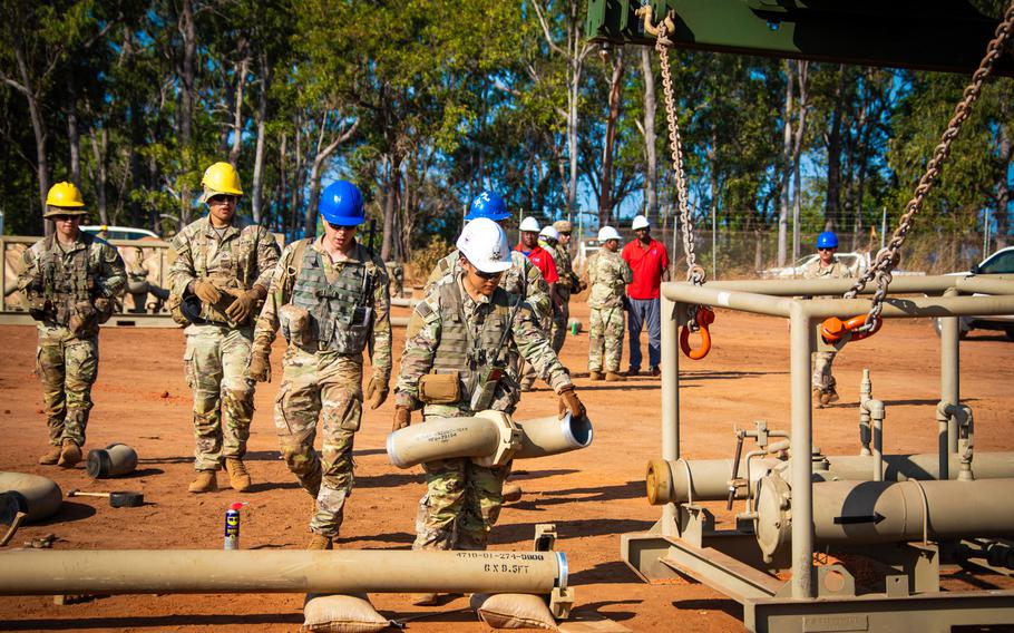 U.S. soldiers connect a fuel pipeline to a pump station during the Talisman Sabre exercise in Weipa, Australia, July 20, 2023.