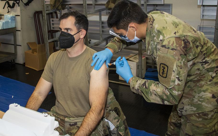 Pfc. Lake Goo gives a COVID-19 booster shot at Kleber Kaserne in Kaiserslautern, Germany, Dec. 8, 2021. Cases among the tens of thousands of U.S. personnel in the area continue to climb, with nearly 70 new cases reported during the previous week by the Kaiserslautern district health office. 