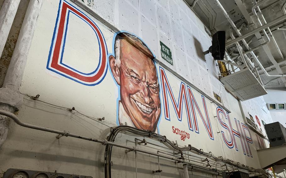 A mural painted by a sailor in the hangar bay of the aircraft carrier USS Dwight D. Eisenhower depicts the ship's namesake over the words "Best Damn Ship in the Navy." 
