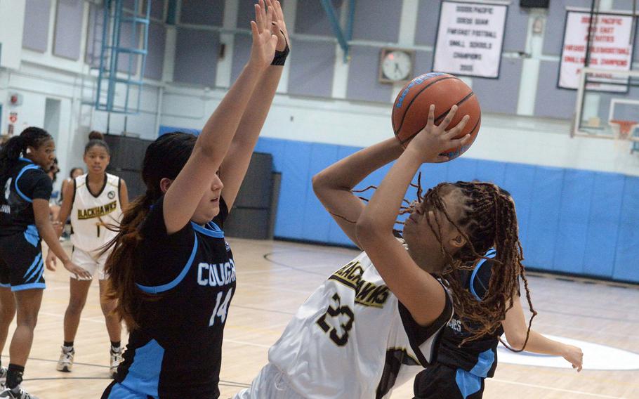 Humphreys' Jaelynn Leverette shoots against Osan's Ashley Kim during Friday's DODEA-Korea girls basketball game. The Blackhawks won the Korea inter-division battle 51-17, handing the Cougars their first loss in eight games.