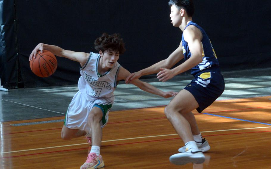 Kubasaki's Troy Harris tries to move around a Taipei American defender during Saturday's Okinawa-American Friendship Tournament pool-play game. The Tigers won 60-42.