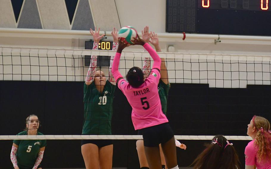 Vicenza’s Ally Taylor softly hits the ball over a pair of Wildcat defenders during the first set as the Vicenza Cougars play the Naples Wildcats at Vicenza High School on Oct. 13, 2023. 
