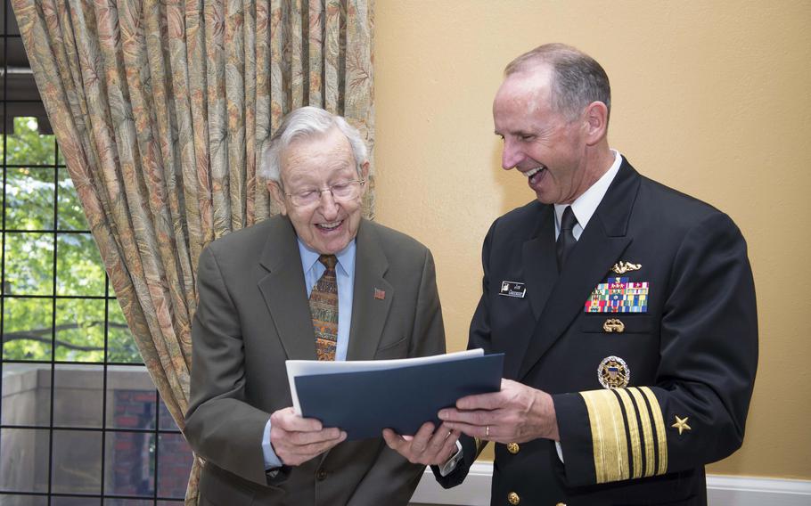 Then-Chief of Naval Operations Adm. Jonathan Greenert, right, reflects on photos with Thomas B. Hayward, the 21st CNO, in Seattle on Sept. 24, 2013. 