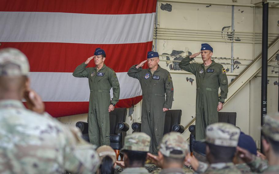 Lt. Gen. David Iverson, left to right, commander of 7th Air Force; Col. Matthew Gaetke, outgoing 8th Fighter Wing commander; and Col. Peter Kasarskis, incoming wing commander, salute the colors during a change-of-command ceremony at Kunsan Air Base, South Korea, June 7, 2024. 