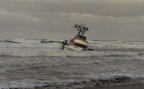 The 61-foot crab boat Genesis is grounded on a sandbar off Leadbetter Point at the entrance to Willapa Bay, Wash, Jan. 25, 2013. The Coast Guard rescued all four crewmembers and a dog and transferred them to Coast Guard Sector Columbia River located in Warrenton, Ore. U.S. Coast Guard photo.