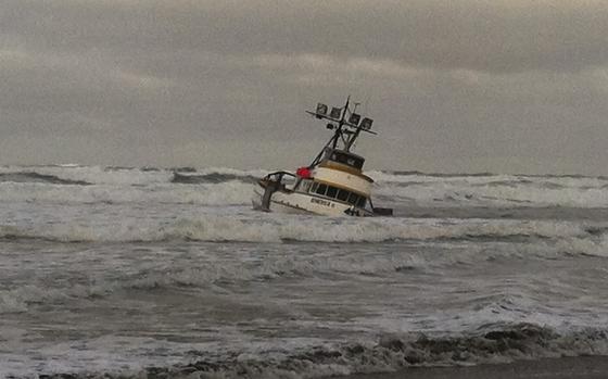 The 61-foot crab boat Genesis is grounded on a sandbar off Leadbetter Point at the entrance to Willapa Bay, Wash, Jan. 25, 2013. The Coast Guard rescued all four crewmembers and a dog and transferred them to Coast Guard Sector Columbia River located in Warrenton, Ore. U.S. Coast Guard photo.