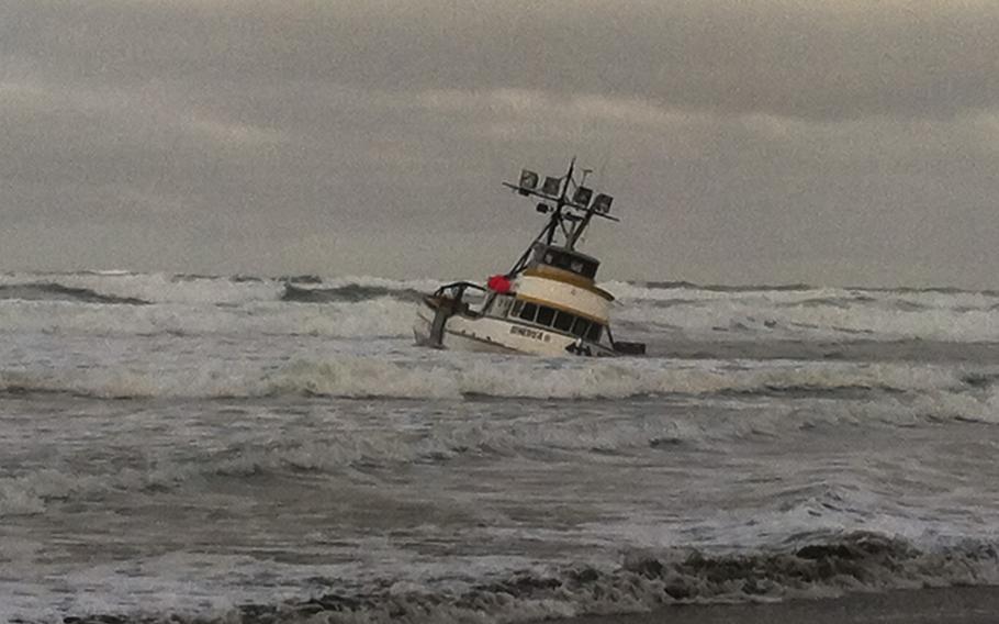 The 61-foot crab boat Genesis is grounded on a sandbar off Leadbetter Point at the entrance to Willapa Bay, Wash, Jan. 25, 2013. The Coast Guard rescued all four crewmembers and a dog.
