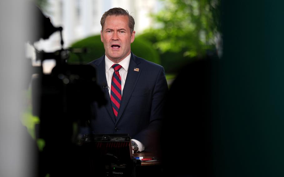 Mike Waltz talks in front of cameras, with out-of-focus reporters and their gear taking up most of the image in the foreground.