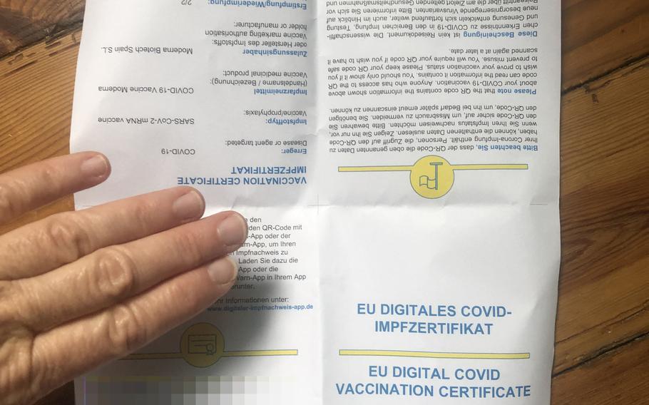 A print-out of the digital COVID-19 vaccination certificate obtained in Kaiserslautern, Germany, June 22, 2021, includes a QR code and personal data, obscured, and information about which vaccine was received and when. Two certificates, one for each vaccine dose, were issued to a U.S. citizen in Kaiserslautern within minutes on presentation of a photo ID and a CDC vaccine card.