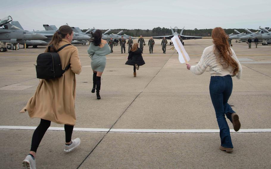 Aviators assigned to Strike Fighter Squadron (VFA) 31, “Tomcatters,” greet loved ones on the flightline after their homecoming flight to Naval Air Station Oceana, Jan. 15, 2024.
