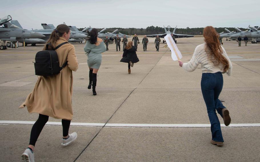 Aviators assigned to Strike Fighter Squadron (VFA) 31, “Tomcatters,” greet loved ones on the flightline after their homecoming flight to Naval Air Station Oceana, Jan. 15, 2024.