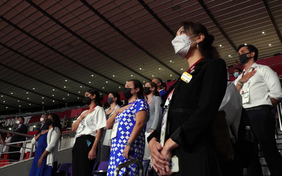 People stand for the U.S. national anthem ahead of a Paralympics wheelchair rugby match between the United States and New Zealand at Yoyogi National Stadium in Tokyo, Wednesday, Aug. 25, 2021.