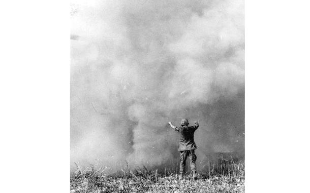 South Vietnam, March, 1967: The conductor of this symphony of dust is actually helping guide an 11th Aviation Battalion helicopter as it lands troops in War Zone C, near the Cambodian border. The dust was kicked up by the copter's rotor blades.

Looking for Stars and Stripes’ coverage of the Vietnam War? Subscribe to Stars and Stripes’ historic newspaper archive! We have digitized our 1948-1999 European and Pacific editions, as well as several of our WWII editions and made them available online through https://starsandstripes.newspaperarchive.com/

META TAGS: Vietnam War; Cambodia; combat; 