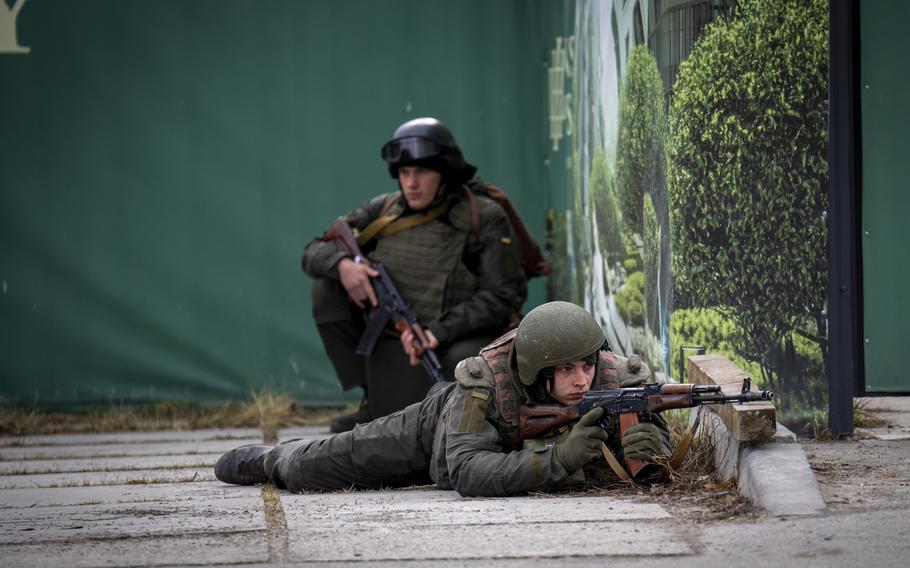 Ukrainian soldiers take positions in downtown Kyiv, Ukraine, Friday, Feb. 25, 2022. Russia pressed its invasion of Ukraine to the outskirts of the capital Friday after unleashing airstrikes on cities and military bases and sending in troops and tanks from three sides in an attack that could rewrite the global post-Cold War security order.